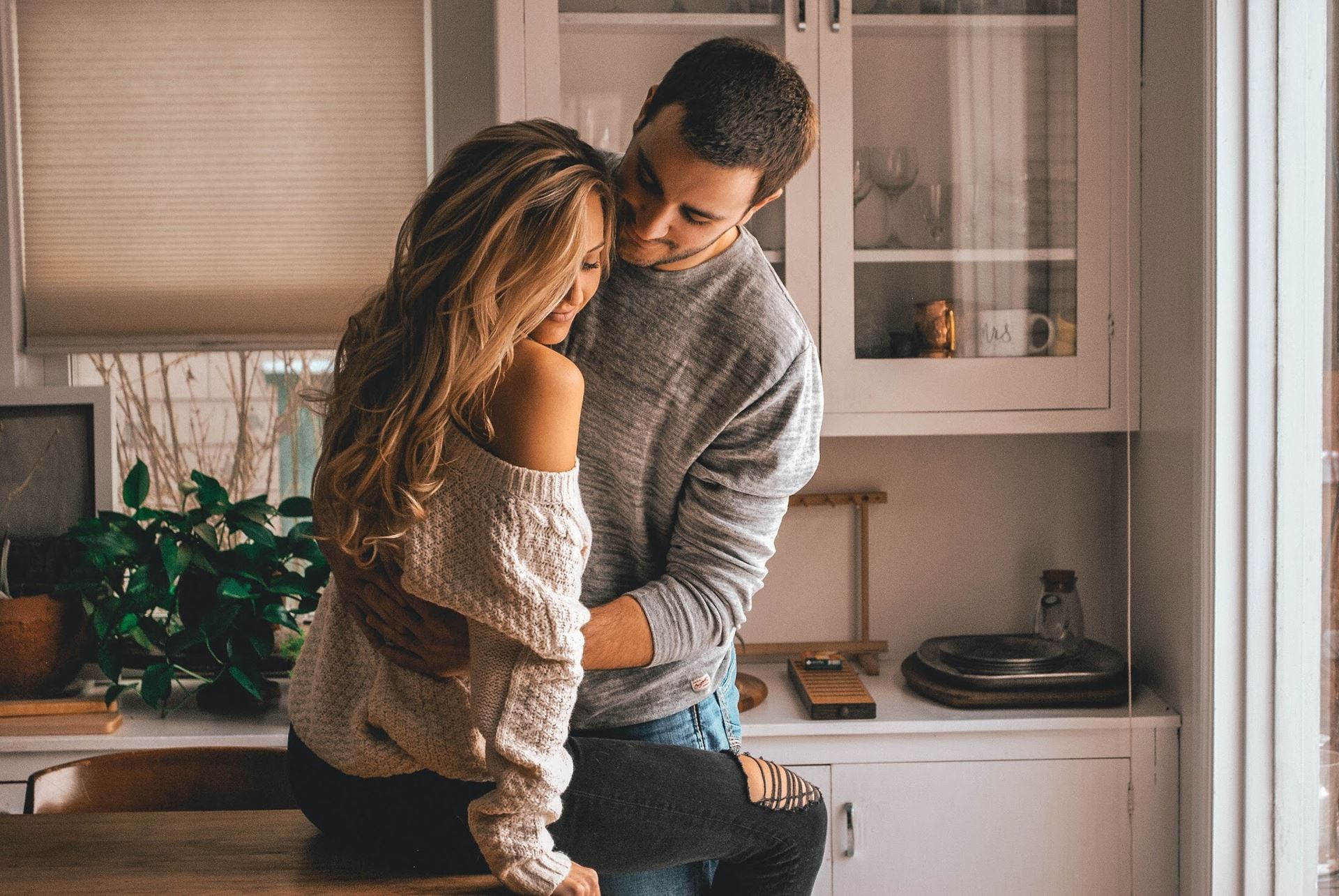 a couple standing in a kitchen